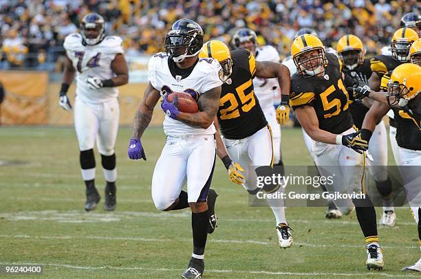 Running back Willis McGahee of the Baltimore Ravens is chased by defensive back Ryan Clark and linebacker James Farrior of the Pittsburgh Steelers...