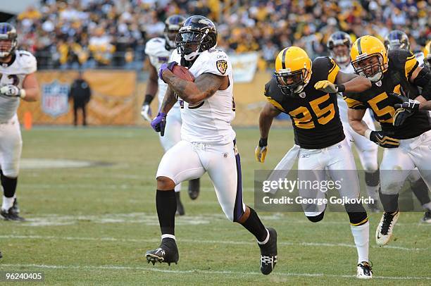 Running back Willis McGahee of the Baltimore Ravens is chased by defensive back Ryan Clark and linebacker James Farrior of the Pittsburgh Steelers...