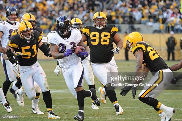 Running back Willis McGahee of the Baltimore Ravens is chased by linebacker James Farrior, defensive lineman Casey Hampton and defensive back Ike...