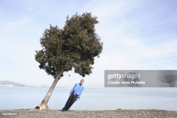 male leaning with tree - kromme stock-fotos und bilder