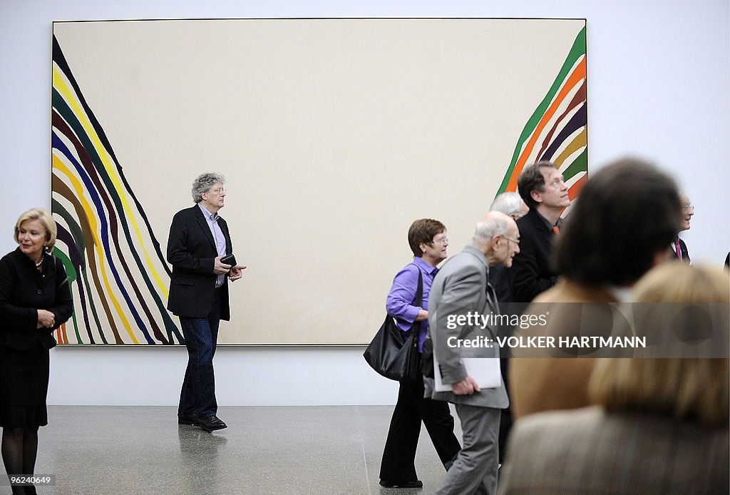 Visitors walk past the painting "KSI" (a
