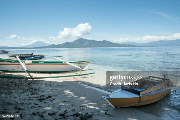 boats on shore - manado stock pictures, royalty-free photos & images