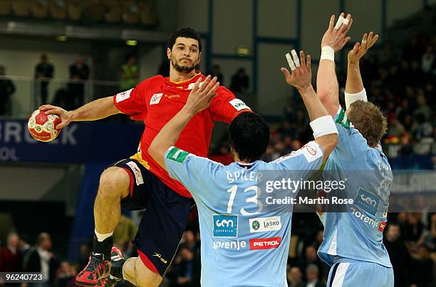 David Spiler and Miha Zvizej of Slovenia in action with Iker Romero of Spain during the Men's Handball European main round Group II match between...