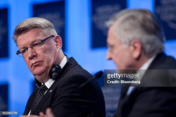 Valdis Zatlers, president of Latvia, left, listens as Jean-Claude Trichet, president of the European Central Bank , speaks during a panel discussion...