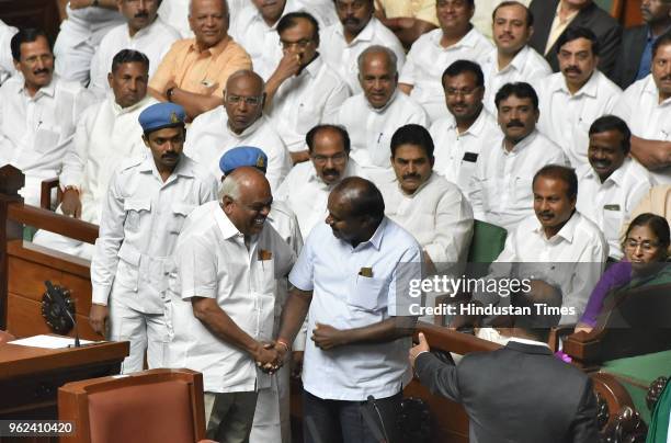 Chief Minister of Karnataka H. D. Kumaraswamy greets the newly elected Speaker Ramesh Kumar during a special session to prove the majority of...