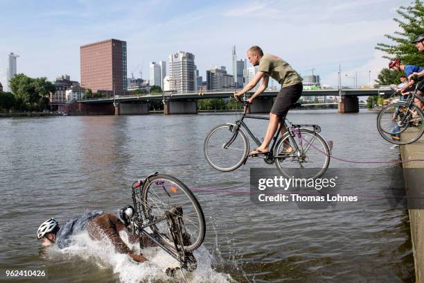 Bicyclists ride into the Main River during an organized protest action on May 25, 2018 in Frankfurt, Germany. The cyclists were seeking support for...