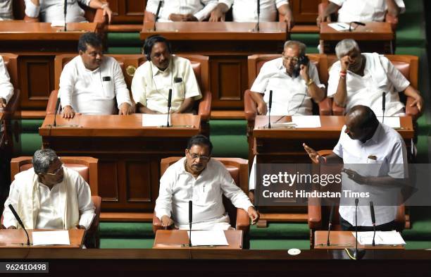 Chief Minister of Karnataka H. D. Kumaraswamy speaks as Deputy Chief Minister Dr G Parameshwara and former Chief Minister Siddaramaiah look on during...