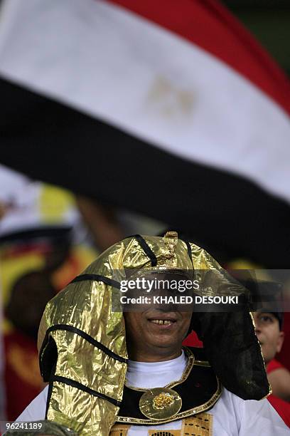 Egyptian fans dressed with pharonic costums cheer for their national team in the Ombaka stadium in Benguela on January 28 before their semi final...