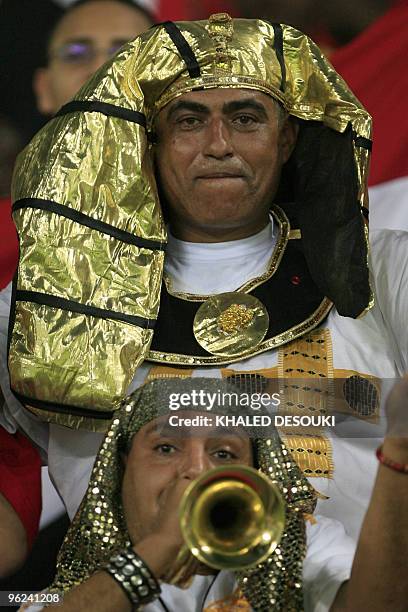 Egyptian fans dressed with pharonic costums cheer for their national team in the Ombaka stadium in Benguela on January 28 before their semi final...