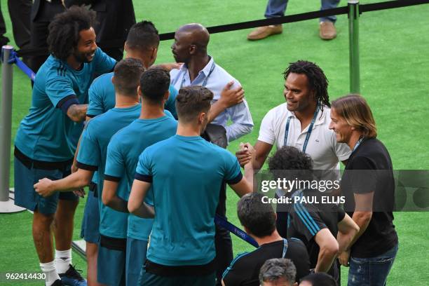 Former Real Madrid players Claude Makelele , Christian Karembeu and Michel Salgado greet Real Madrid players at a team training session at the...