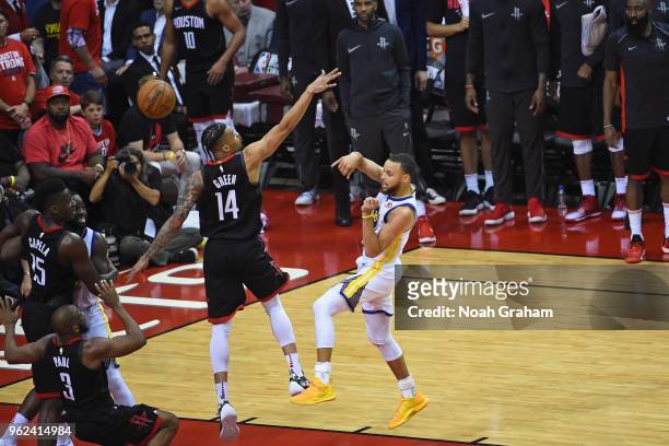 Stephen Curry of the Golden State Warriors passes the ball around Gerald Green of the Houston Rockets in Game Five of the Western Conference Finals...