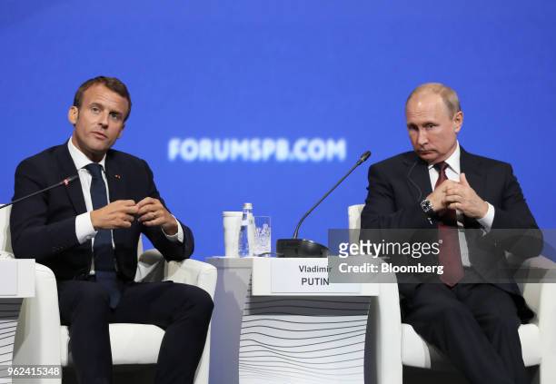 Vladimir Putin, Russia's president, right, and Emmanuel Macron, France's president, look on during the plenary session at the St. Petersburg...