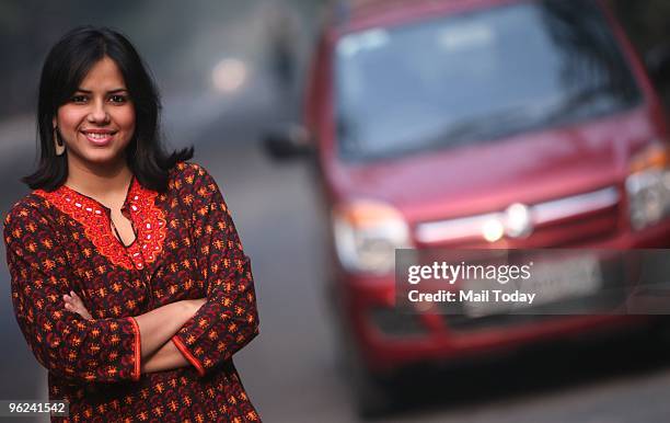 Jewellery designer Suman Mishra, who follows the 'right of way' rule religiously during driving, poses with her car in New Delhi on January 24, 2010.