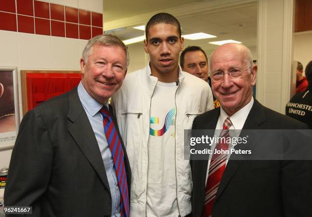 Chris Smalling poses with Sir Alex Ferguson and Sir Bobby Charlton of Manchester United after signing a contract to join Manchester United at the...