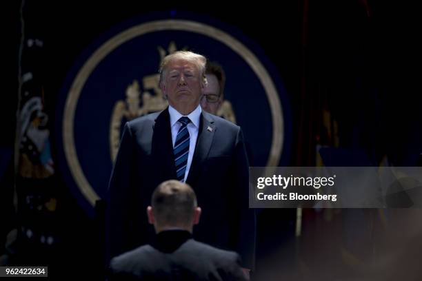 President Donald Trump waits to shake the hand of a graduating midshipman during the United States Naval Academy graduation and commissioning...