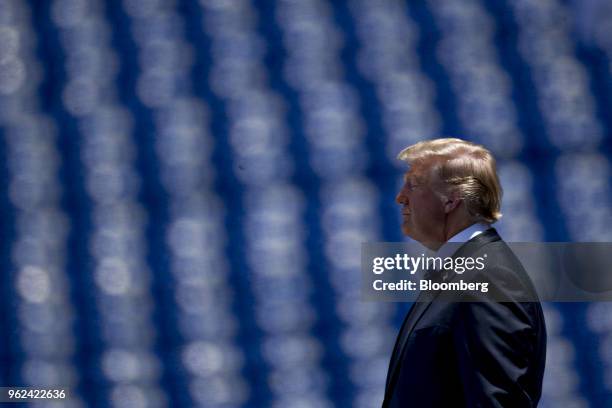 President Donald Trump waits to shake the hand of a graduating midshipman during the United States Naval Academy graduation and commissioning...