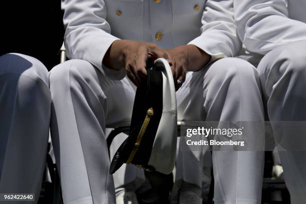 Graduating midshipman holds his cap during the United States Naval Academy graduation and commissioning ceremony at the Navy-Marine Corps Memorial...