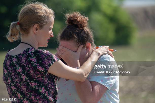 Substitute teacher Joanie Lynne, consoles instructional assistant Paige Rose outside Noblesville West Middle School after a shooting at the school on...