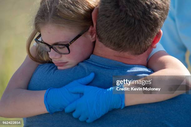 Staff and students comfort each other outside Noblesville West Middle School after a shooting at the school on May 25, 2018 in Noblesville, Indiana....