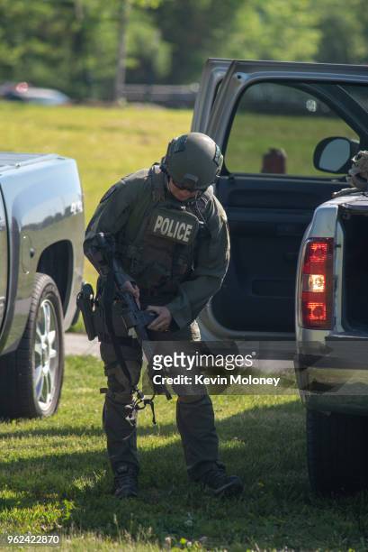 Officer loads his weapon outside Noblesville West Middle School after a shooting at the school on May 25, 2018 in Noblesville, Indiana. One teacher...