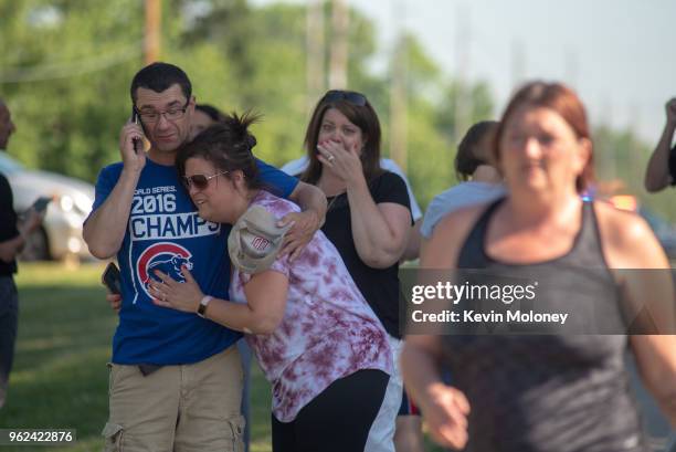 Parents comfort each other as they wait outside Noblesville West Middle School after a shooting at the school on May 25, 2018 in Noblesville,...