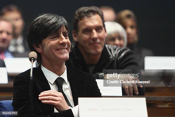 National coach Joachim Loew of Germany and bodybuilder and actor Ralph Moeller smile during the laudation during the German Future Award 2009 at the...