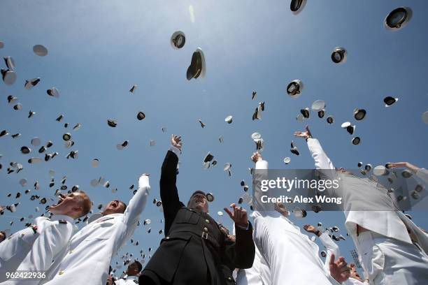 Graduates toss their caps during a graduation ceremony at the Navy-Marine Corps Memorial Stadium of the U.S. Naval Academy May 25, 2018 in Annapolis,...