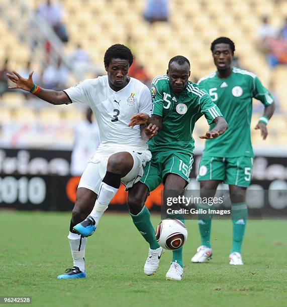 Asamoah Gyan of Ghana and Sani Kaita of Nigeria compete during the Africa Cup of Nations semi final match between Ghana and Nigeria from the November...