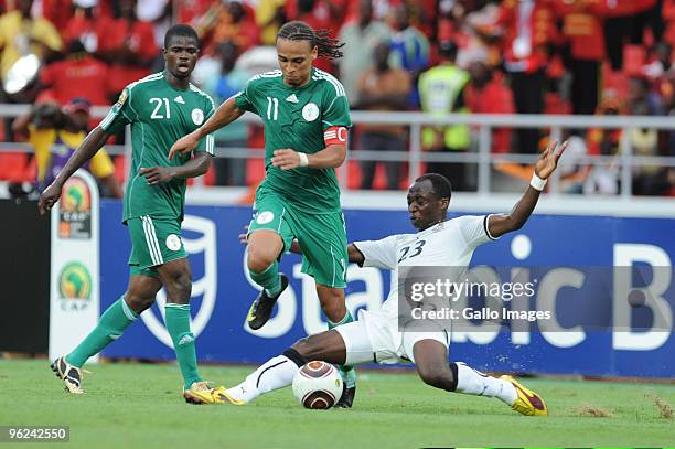 Peter Odemwingie of Nigeria and Haminu Dramani of Ghana compete during go for the ball during the Africa Cup of Nations semi final match between...