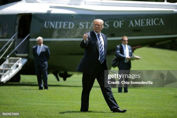 President Donald Trump gives a thumbs-up as he walks across the South Lawn after returning to the White House May 25, 2018 in Washington, DC. Trump...