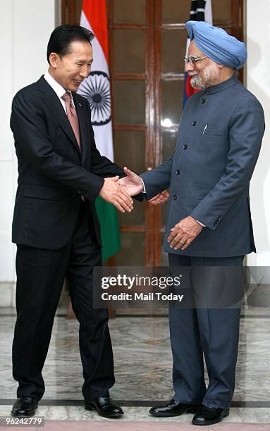 South Korean President Lee Myung-bak shakes hands with Prime Minister Manmohan Singh before a Meeting at Hyderabad House in New Delhi on Monday,...