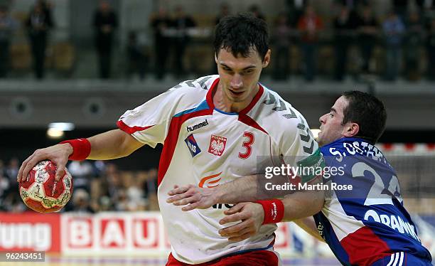 Krysztof Lijewski of Poland in action with Sebastien Ostertag of France during the Men's Handball European main round Group II match between Poland...