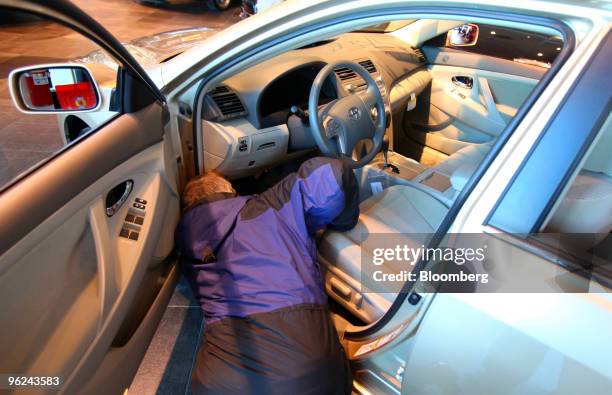 Sales manager Brian Monks looks at the gas pedal inside a new Toyota Camry at Bredemann Toyota in Park Ridge, Illinois, U.S., on Thursday, Jan. 28,...