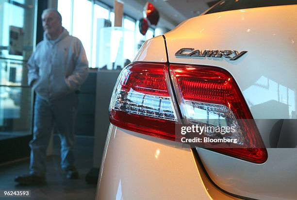 Car shopper walks past a new Toyota Camry at Bredemann Toyota in Park Ridge, Illinois, U.S., on Thursday, Jan. 28, 2010. Toyota Motor Corp., the...