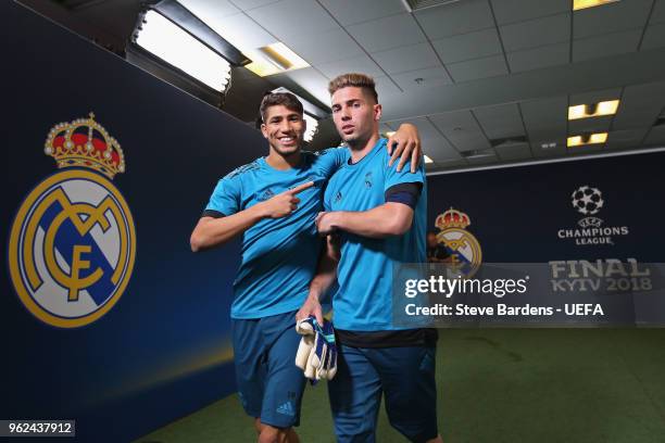 In this handout image provided by UEFA, Achraf Hakimi and Luca Fernndez of Real Madrid walk down the tunnel during a training session ahead of the...