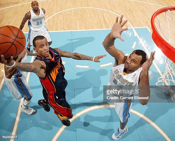 Monta Ellis of the Golden State Warriors shoots a layup against Malik Allen of the Denver Nuggets during the game at Pepsi Center on January 5, 2010...