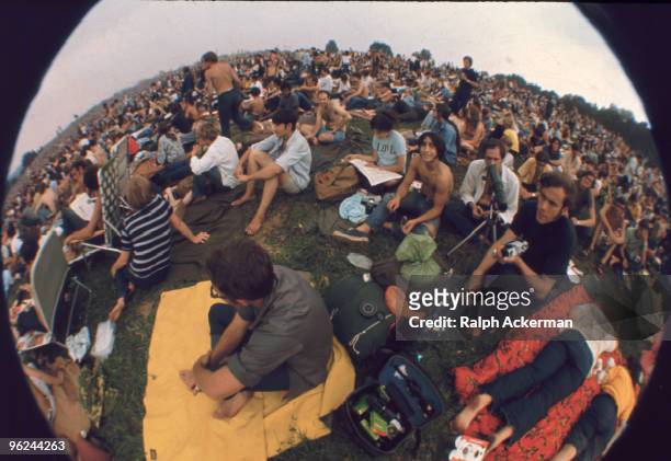Fisheye view of a portion of the audience, which includes several photographers, during the Woodstock Music and Arts Fair, Bethel, New York, August...