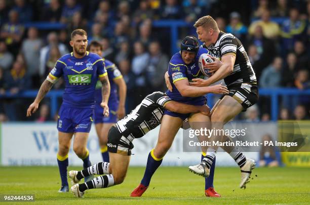 Warrington Wolves' Chris Hill is tackled by Hull FC's Danny Houghton and Chris Green during the Betfred Super League match at the Halliwell Jones...