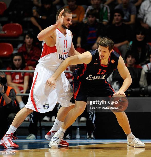 Mirza Teletovic, #12 of Caja Laboral competes with Linas Kleiza, #11 of Olympiacos Piraeus during the Euroleague Basketball 2009-2010 Last 16 Game 1...