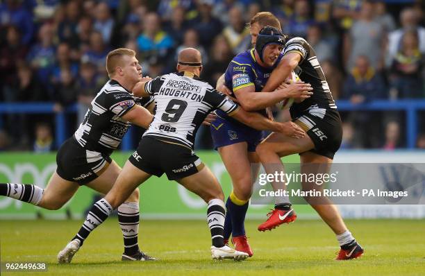 Warrington Wolves' Chris Hill is tackled by Hull FC's Danny Houghton, Brad Fash and Joe Westerman , during the Betfred Super League match at the...