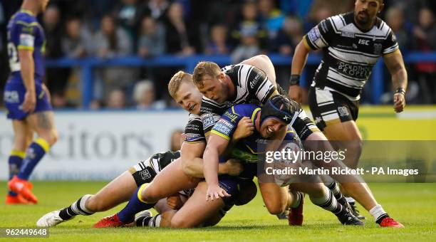 Warrington Wolves' Chris Hill is tackled by Hull FC's Danny Houghton, Brad Fash and Joe Westerman , during the Betfred Super League match at the...