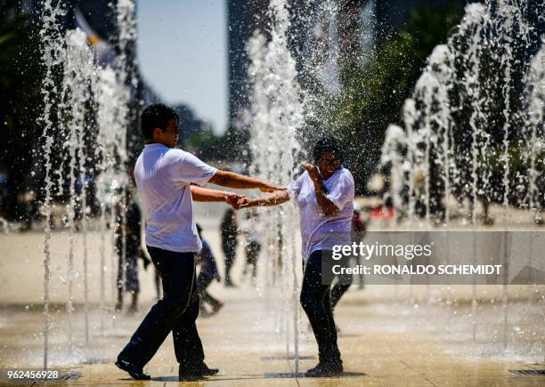 People play in a fountain at the Revolution Monument in Mexico City, on May 25, 2018.