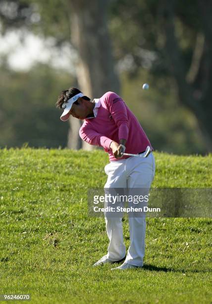 Ryuji Imada of Japan hits his second shot on the eighth hole at the North Course at Torrey Pines Golf Course during the first round of the Farmers...