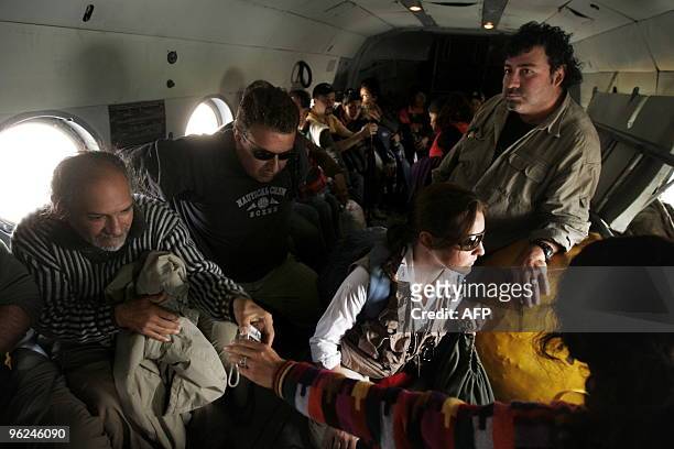 Foreign tourists are evacuated aboard an Mi-8 military helicopter from the village of Aguas Calientes, near the Machu Picchu archaeological site,...