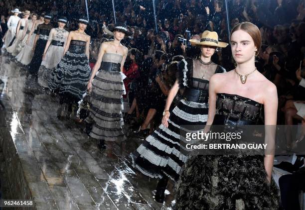 Models present creations for Dior during the 2019 Dior Croisiere fashion show on May 25, 2018 at the Grandes écuries de Chantilly, near Paris.