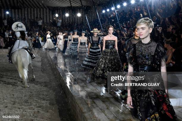 Models present creations for Dior during the 2019 Dior Croisiere fashion show on May 25, 2018 at the Grandes écuries de Chantilly, near Paris.