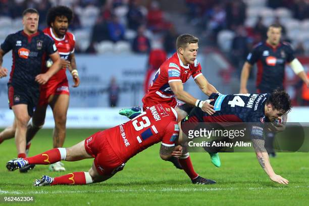 John Bateman of Wigan Warriors is tackled by Ben Kavanagh of Hull KR during the Betfred Super League at KCOM Craven Park on May 25, 2018 in Hull,...