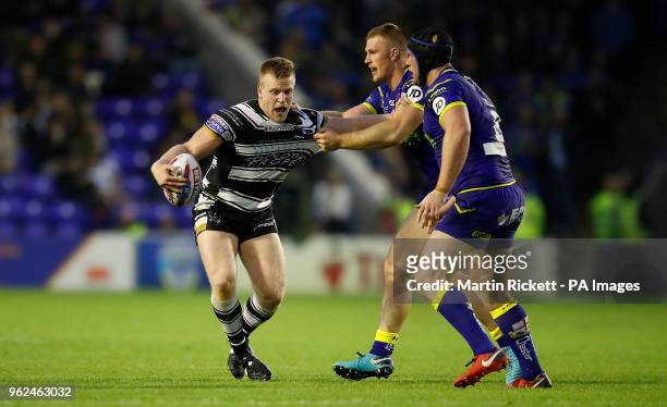 Hull FC's Brad Fash is tackled by Warrington Wolves' Jack Hughes and Chris Hill during the Betfred Super League match at the Halliwell Jones Stadium,...