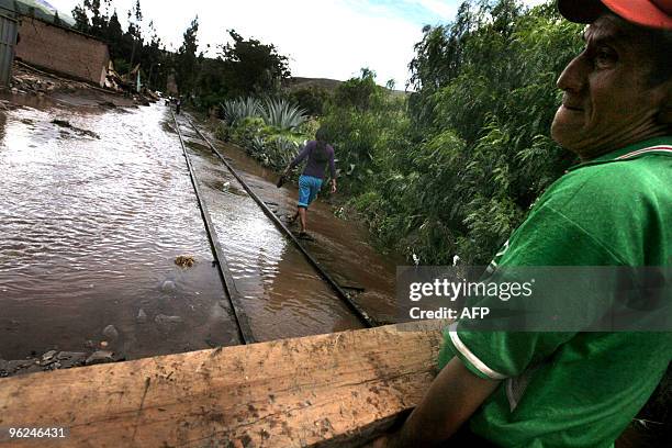 Workers repair the railway tracks, damaged by the flooded Vilcanota river, in the village of Urubamba, near the Machu Picchu archaeological site, in...