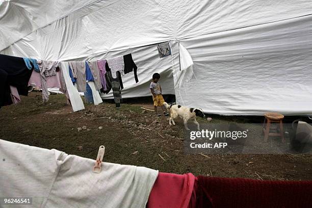 Child walks along a camp set up away from the Vilcanota river in the village of Urubamba, near the Machu Picchu archaeological site in Cuzco on...